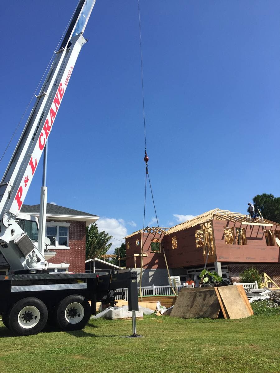 Crane lifting materials on new construction build — Blue Diamond Building