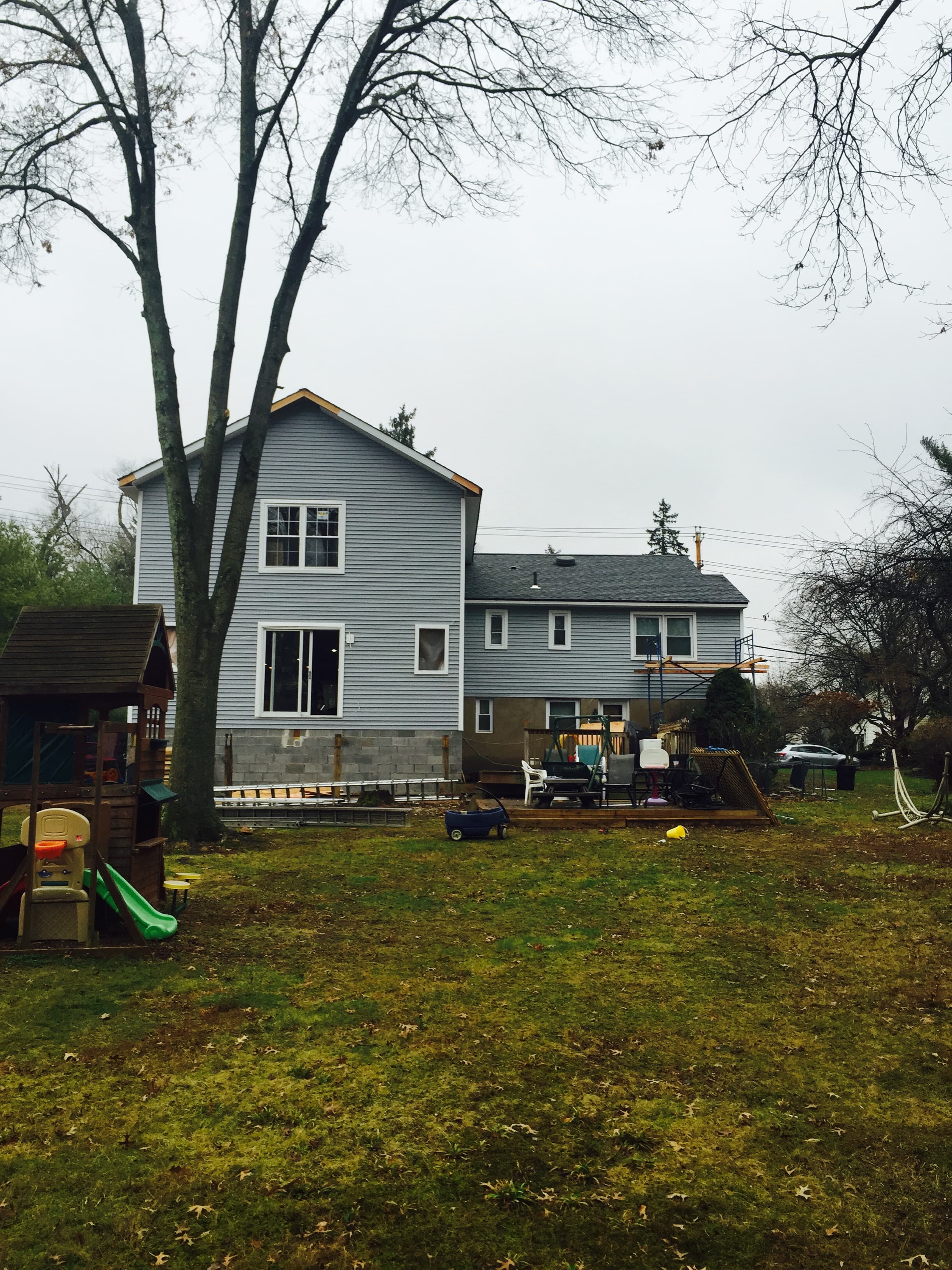 Completed add-a-level home addition with gray siding — Blue Diamond Building
