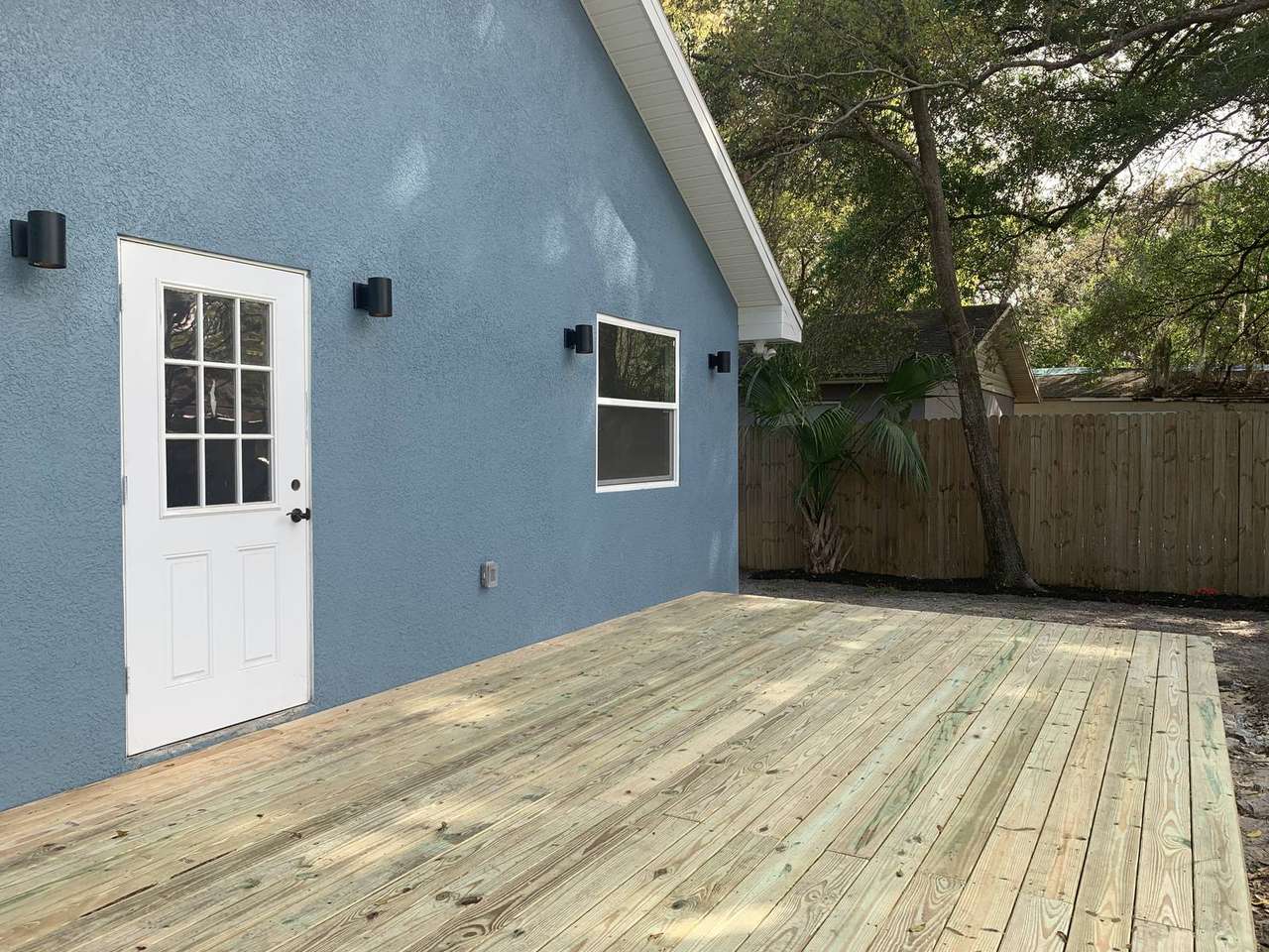 New deck attached to blue house in Florida — Blue Diamond Building