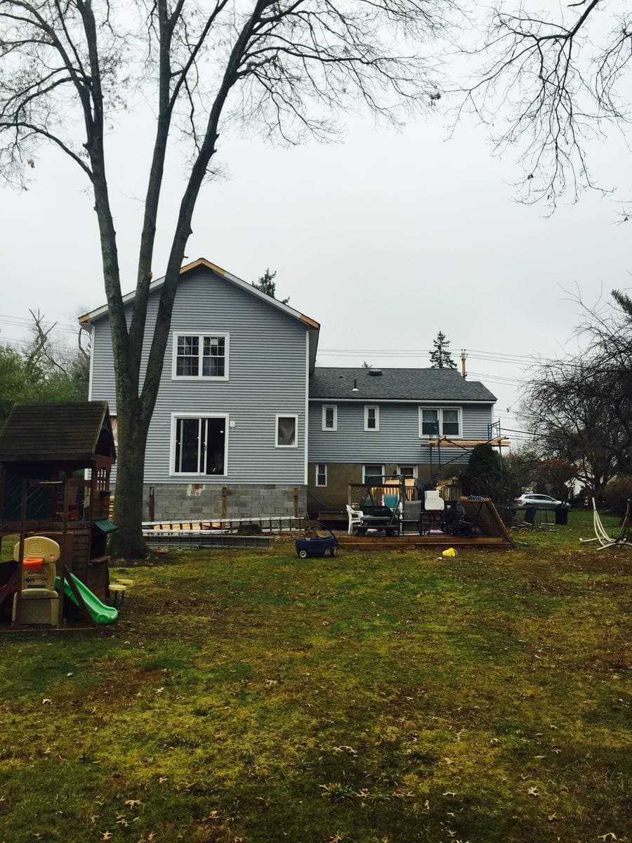 Finished gray fiber cement siding on two-story home — Blue Diamond Building
